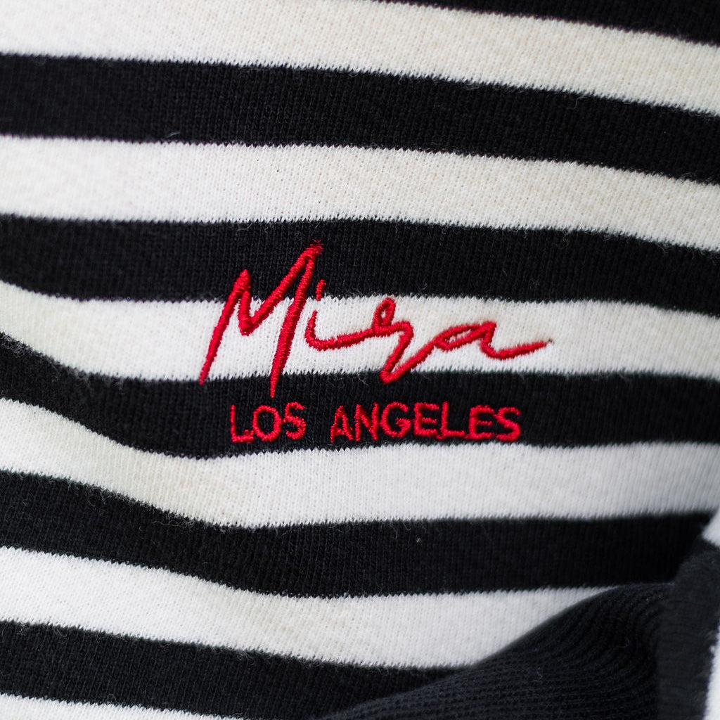 Black and white striped fabric with red 'Miga Los Angeles' logo